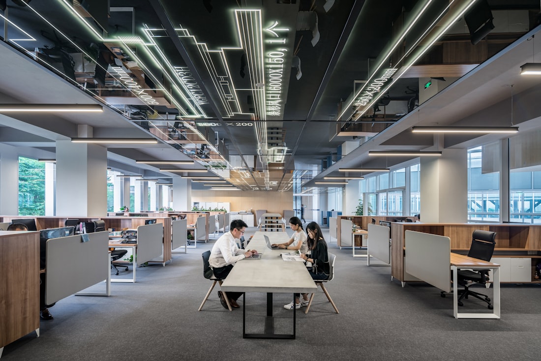 Three colleagues working together in an open-plan studio