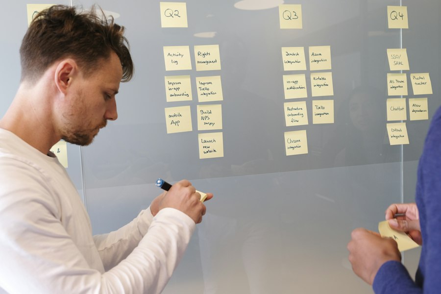 A facilitator working through a pricing model on a whiteboard