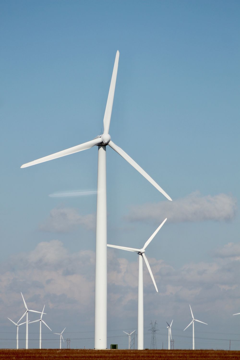 A wind turbine standing above open farmland