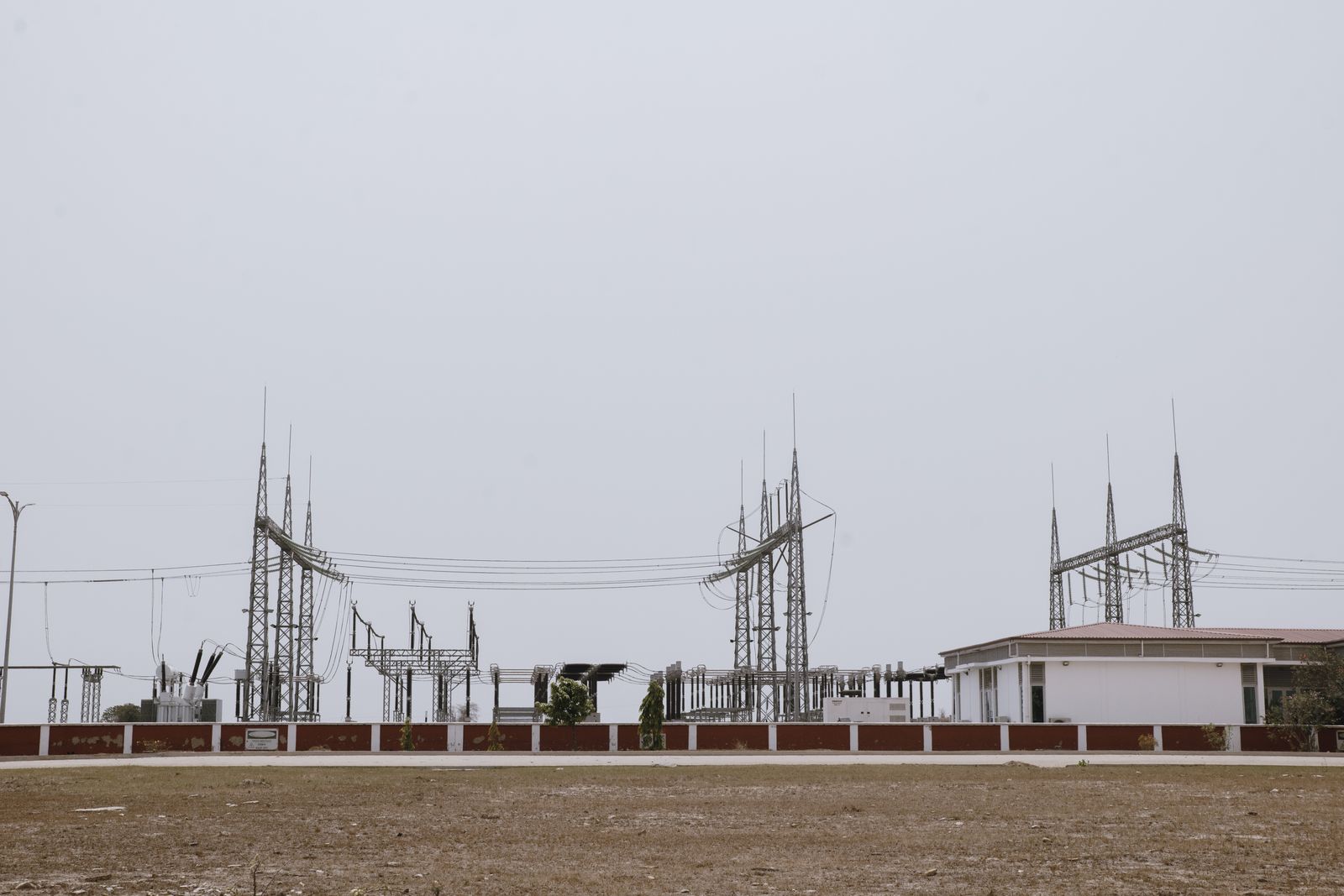High-voltage substation on open ground beneath a clear sky