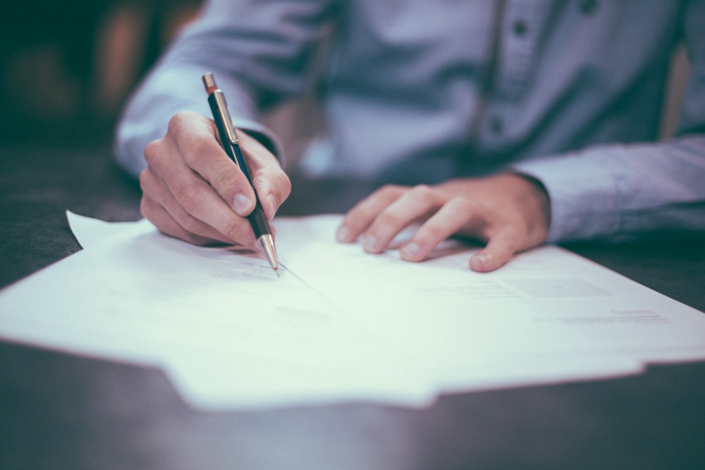 Contracts and documents being signed at a desk